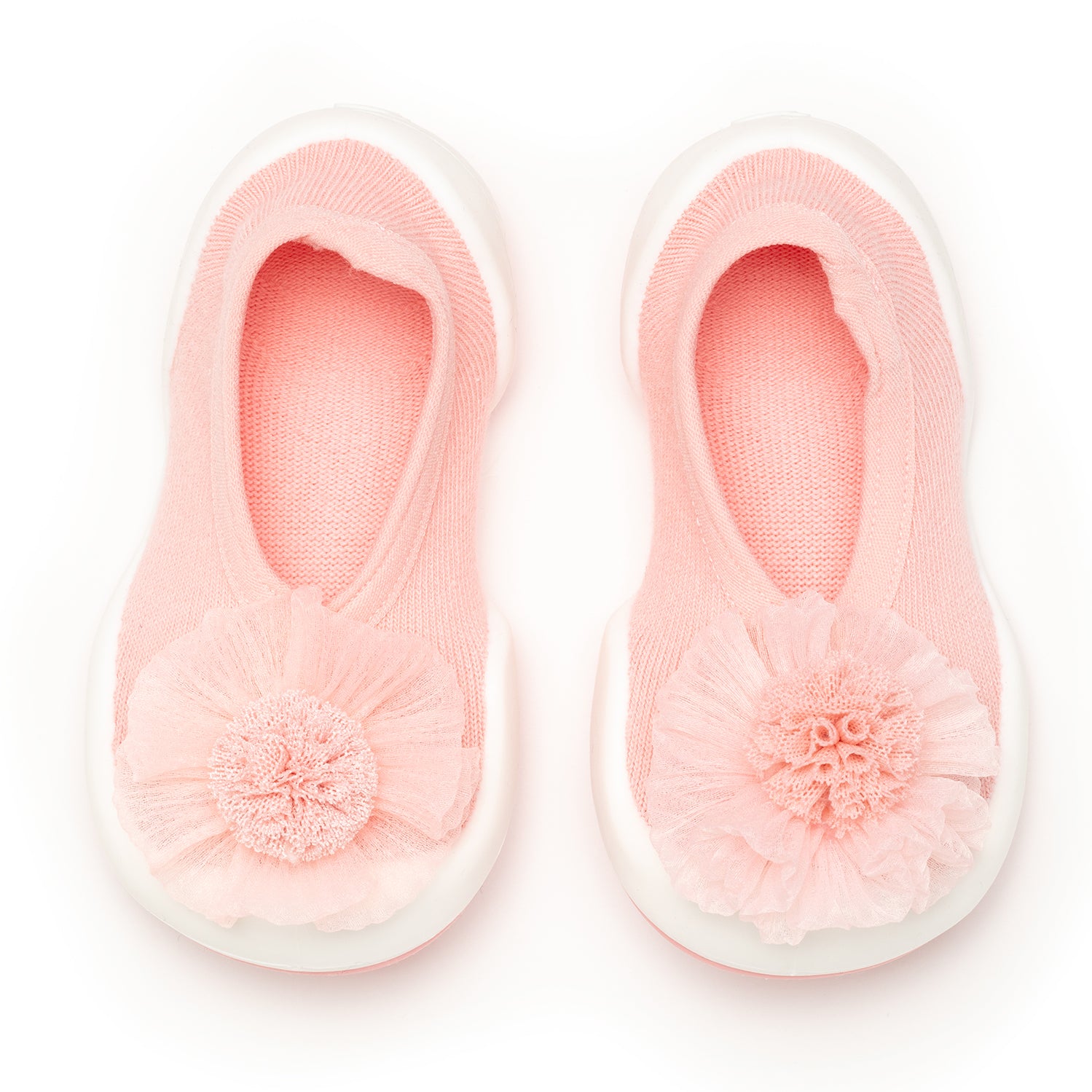 Pair of pink baby shoes with floral embellishments and white soles.