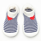 A pair of striped baby shoes with a red heart detail.