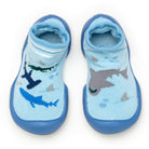 Two light blue baby sock shoes with shark patterns.