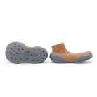 Gray and tan baby shoe and sole.