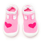 Pair of pink baby shoe socks with hearts and white trim.