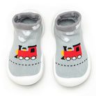 A pair of light gray baby sock shoes with a red train design and white soles.