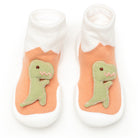 Pair of baby sock-shoes with dinosaur design, white sock top, peach shoe body, and green dino applique.