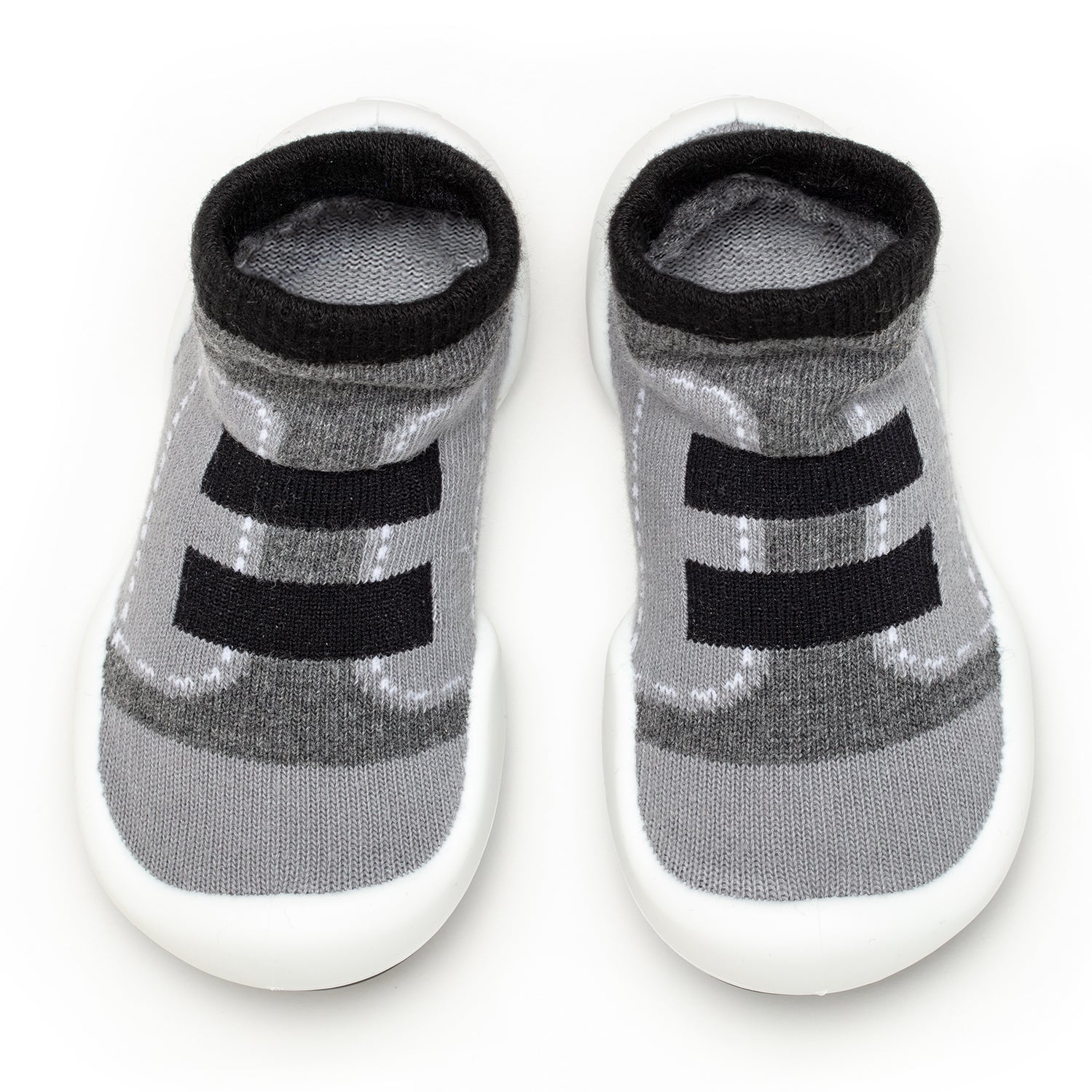 Pair of gray and black baby shoe-socks with white soles.