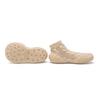 Two beige knit slip-on shoes, one showing the sole.