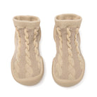 Two beige knitted baby socks.