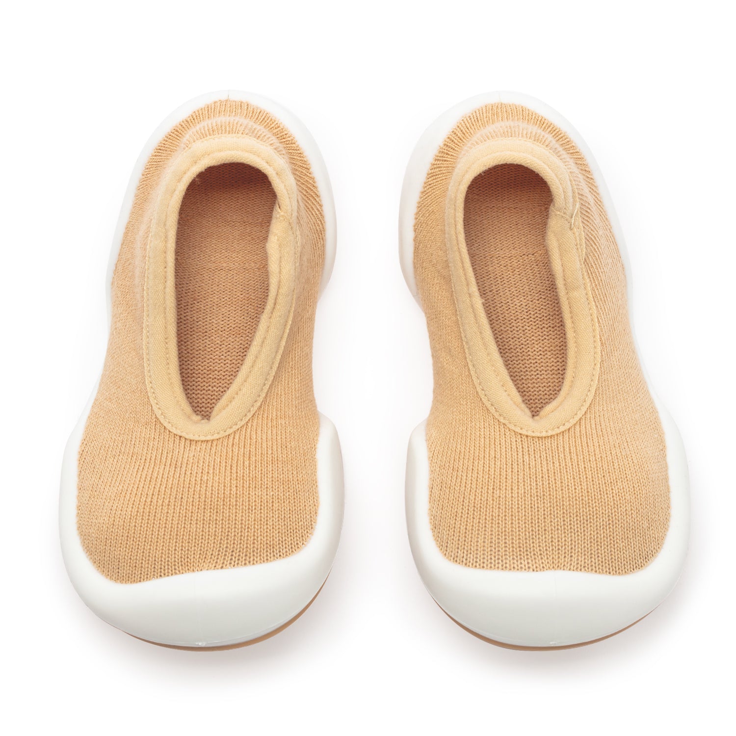 Pair of tan baby sock shoes with white soles.