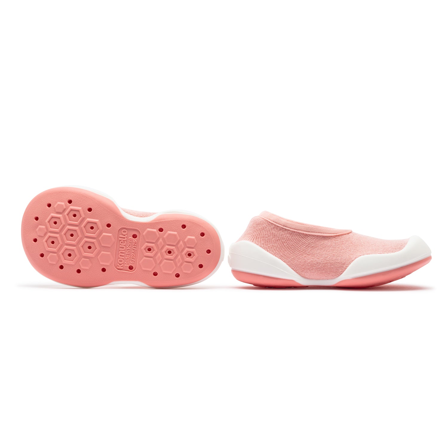 Two pink and white baby shoes, sole up.