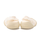 Two beige baby shoes with white lace.
