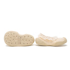 Beige baby shoes with lace trim.