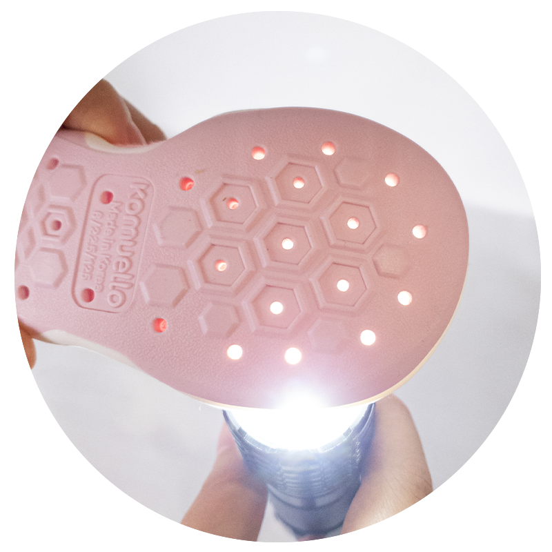 Komuello pink sock shoes bottom sole showing Komuello’s breathable ventilation holes with light passing through.