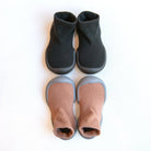 Two pairs of sock-shoes, one black and one light brown.