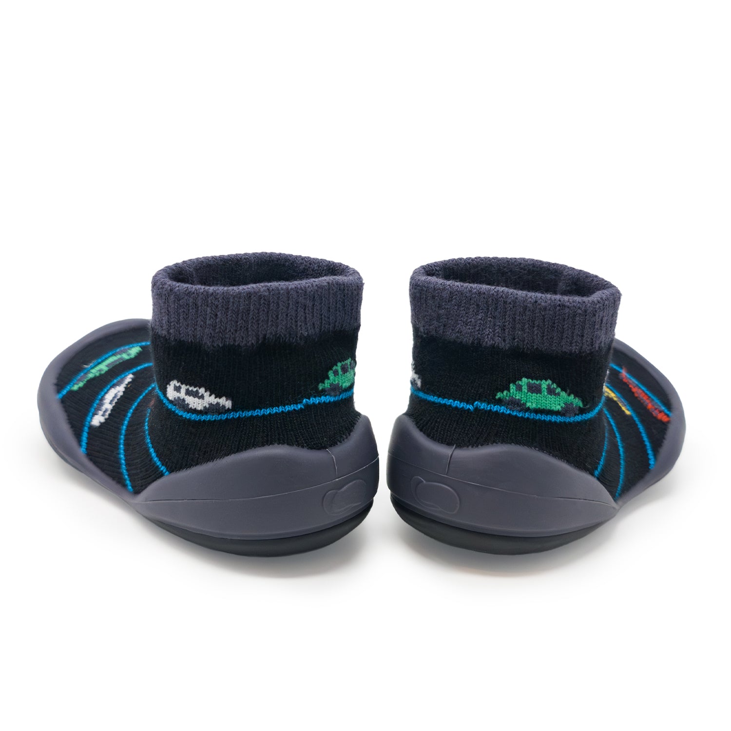 A pair of children's black sock shoes with a gray rubber sole and a pattern of cars.
