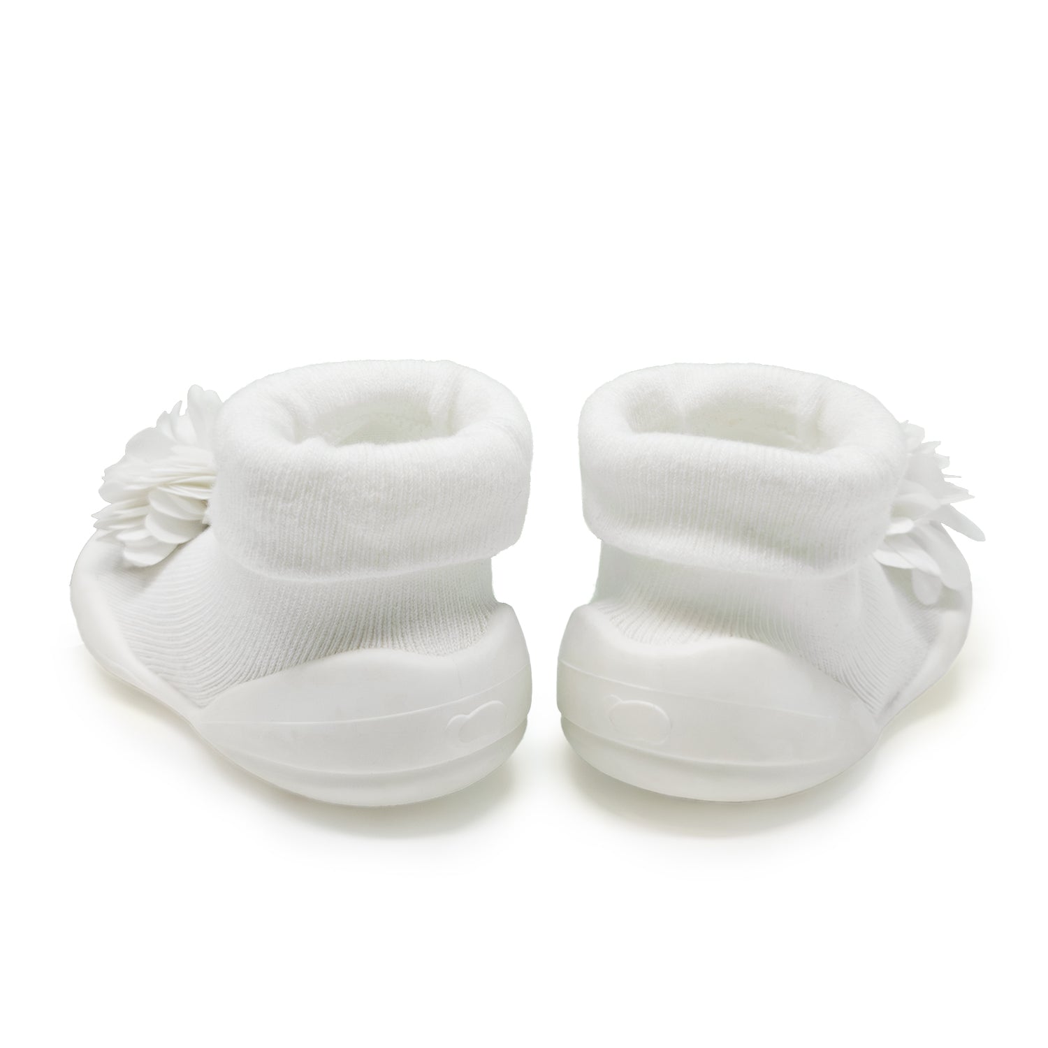 Two white baby shoes with flower detail, back view.