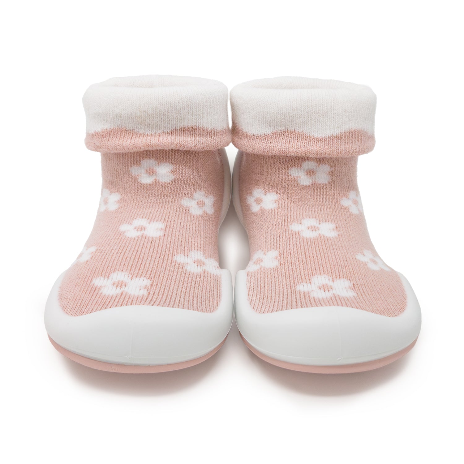 Pair of pink baby shoe socks with white flower pattern.