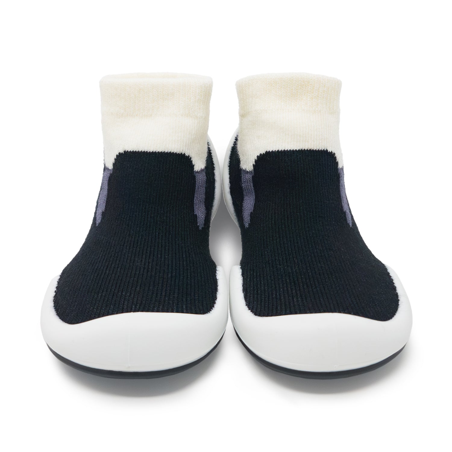 A pair of black and white toddler shoes.