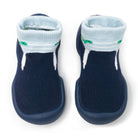 Two navy blue baby socks with light blue cuffs and white stripes, featuring a green alligator pattern.