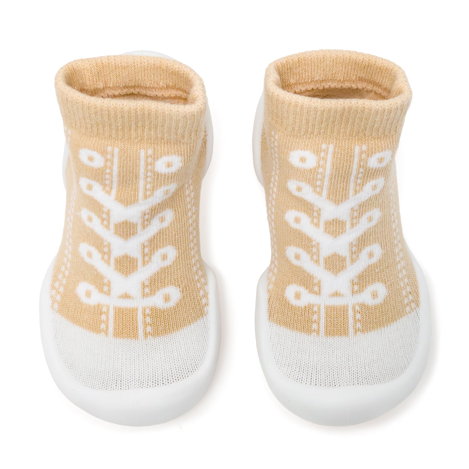 Two tan baby shoes with white soles and laces.