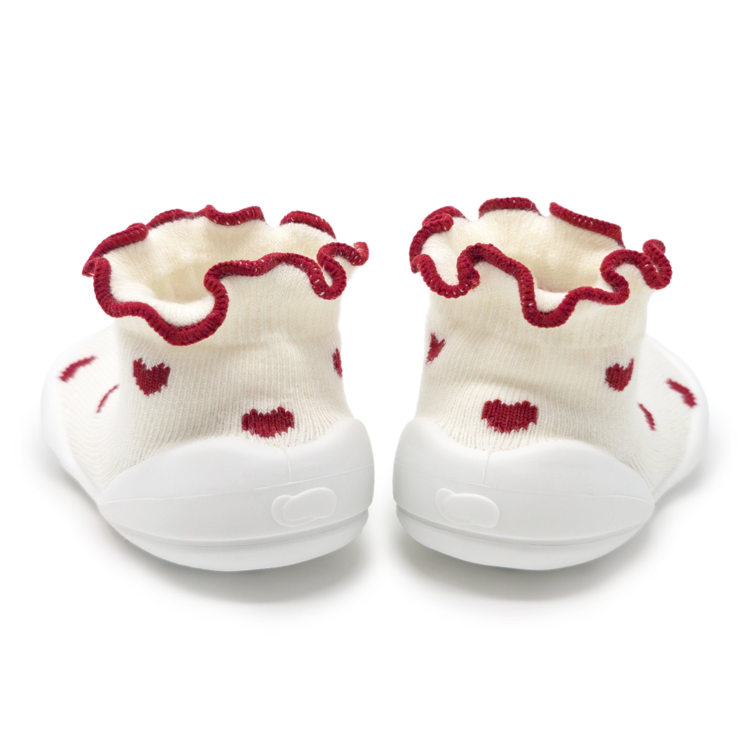 Two white baby booties with red hearts and red ruffled trim.
