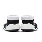 Rear view of baby socks with white, black, and blue accents.