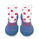 Two baby slipper socks with red dots and bows.