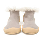 Pair of beige and gray sock-shoes with tulle trim.