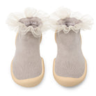 Pair of gray socks with beige rubber soles and white tulle trim.