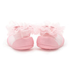 Pink baby shoes with tulle trim.