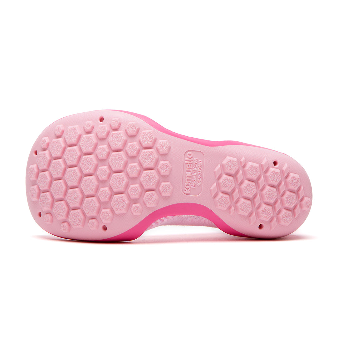 Pink sole of a shoe with a honeycomb pattern.