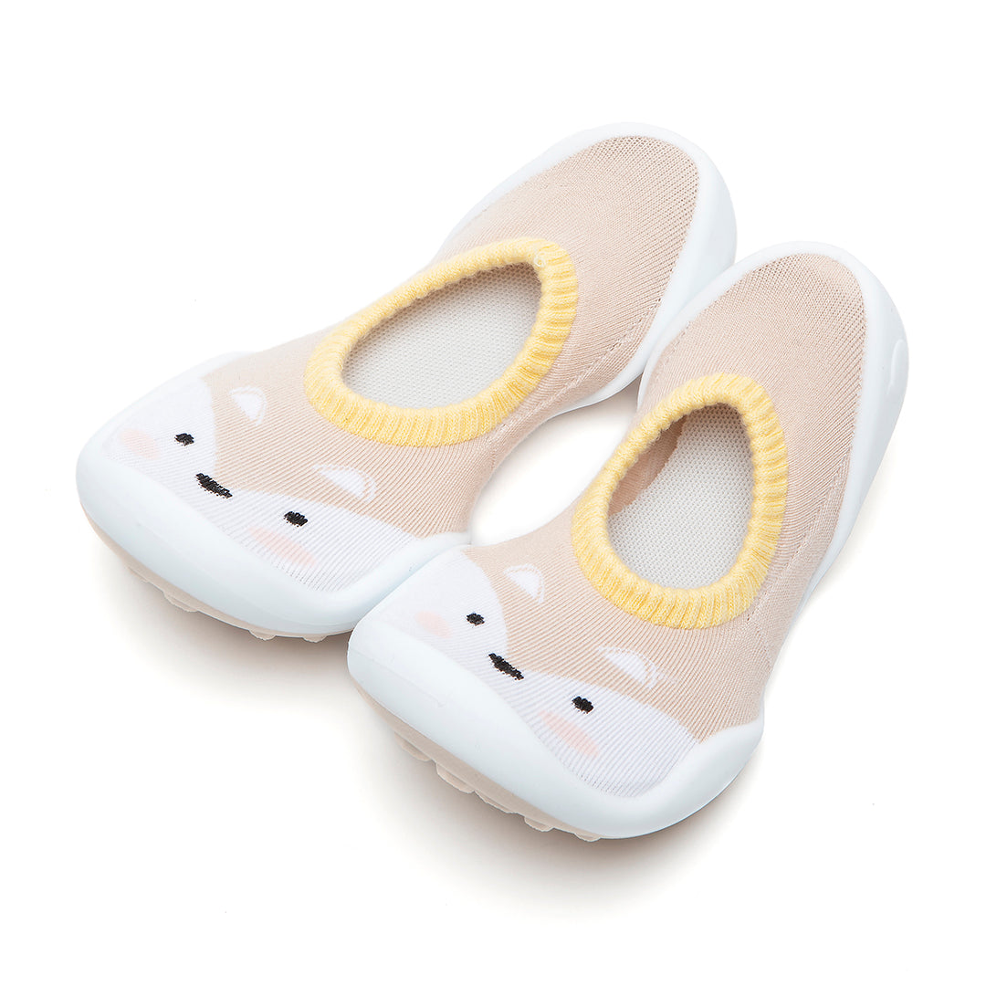 Pair of beige and white baby shoes with a fox design.