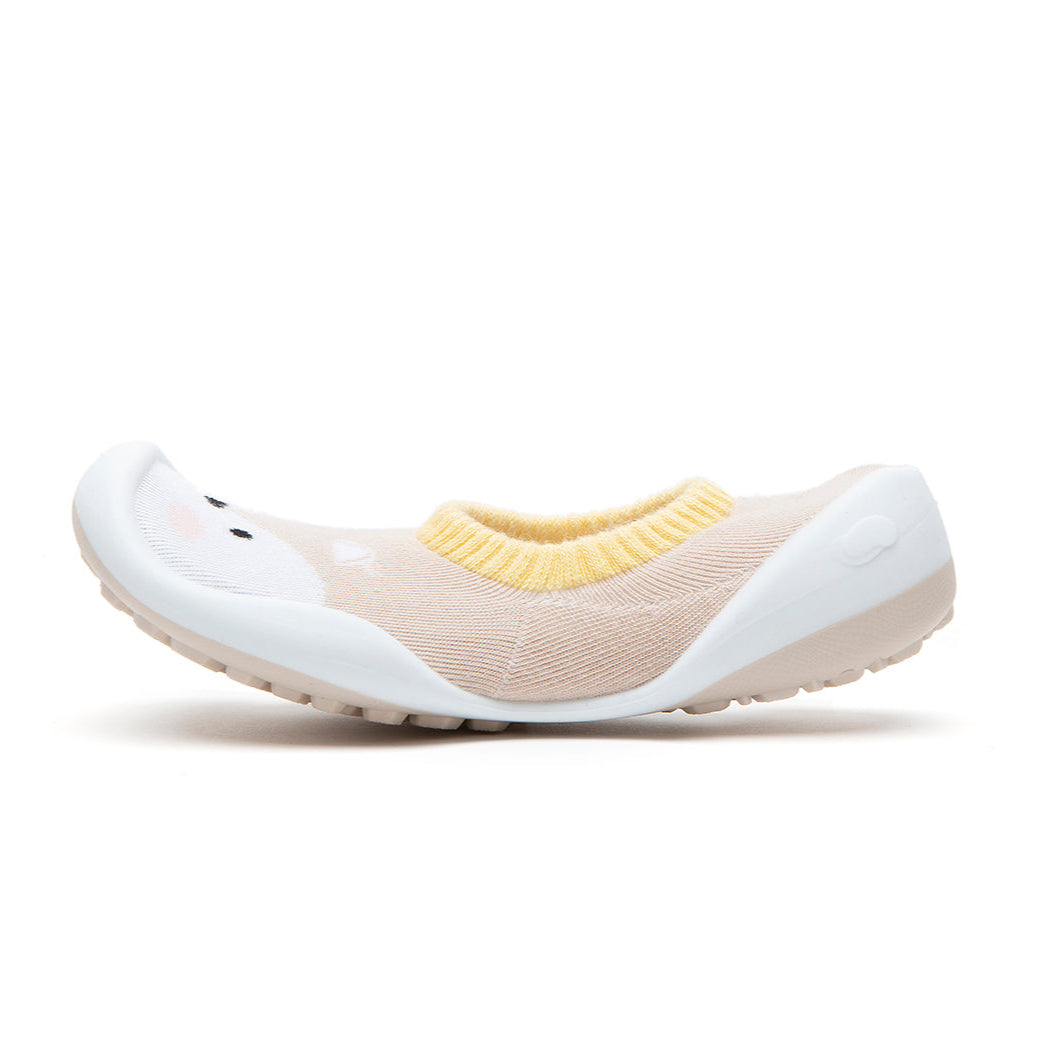 Tan and white knit sock shoe with animal design.