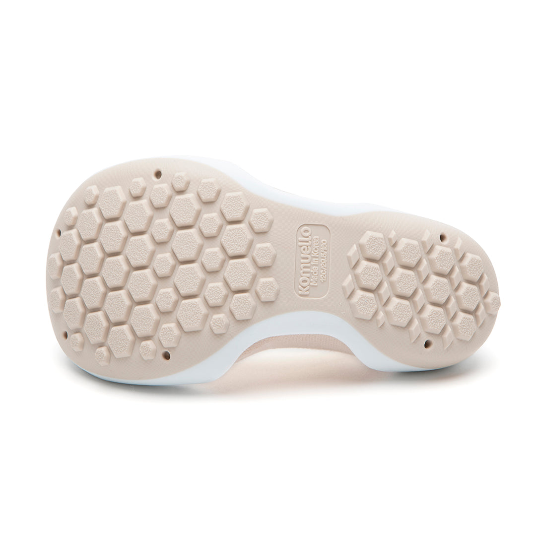 Beige shoe sole with hexagonal treads.