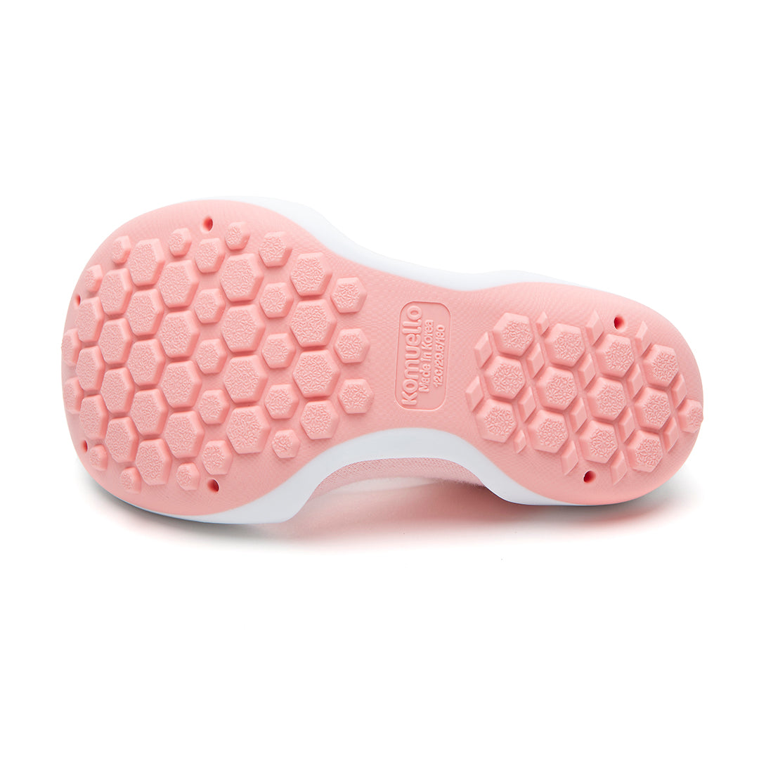 The underside of a pink Komuello shoe with a white rim.