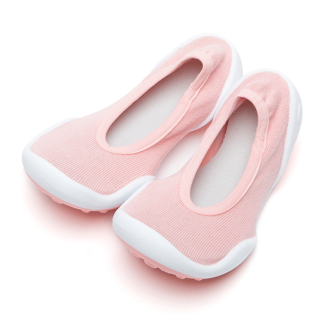 Pair of pink knit shoes with white soles.