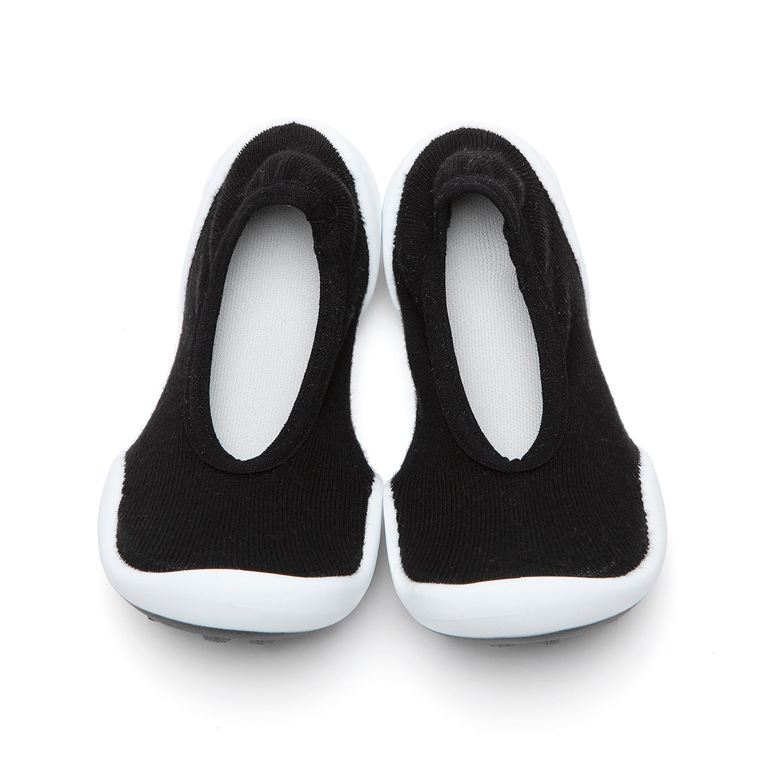 Pair of black and white sock shoes.