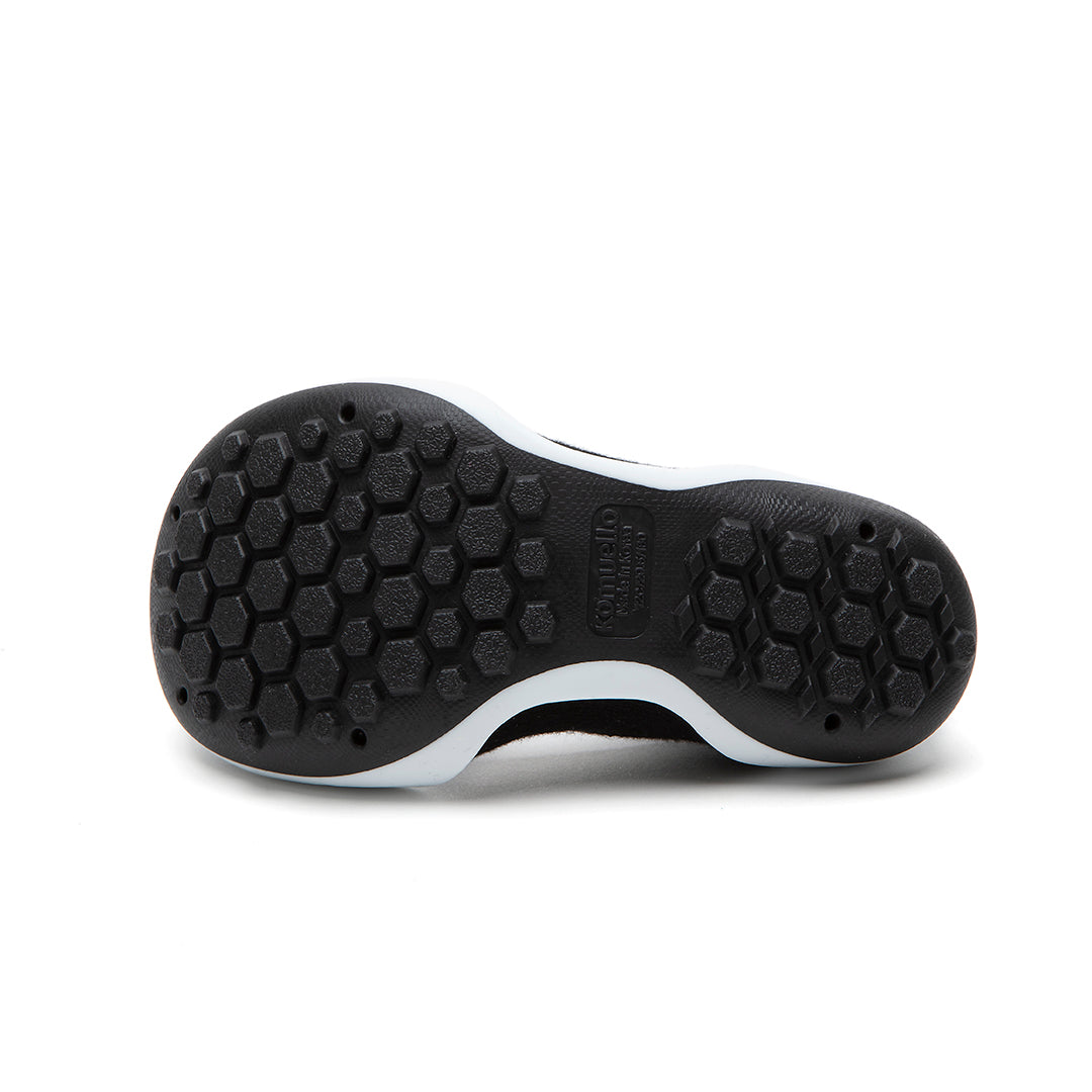 Bottom of black and white shoe.