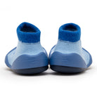 Back view of a pair of blue baby sock shoes on a white background.
