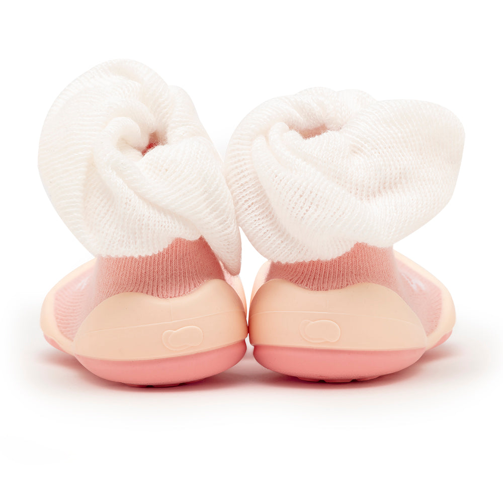 Pair of pink and beige baby sock shoes with white, gathered ankles.