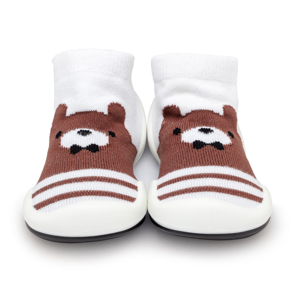 Two brown and white baby booties with bear faces.