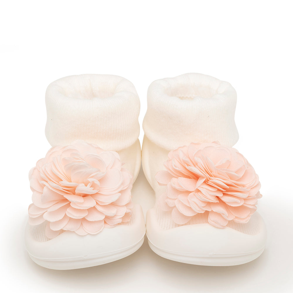 Pair of white baby socks with peach-colored fabric flowers.