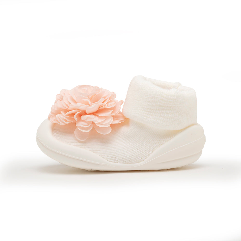White baby shoe with pink flower.