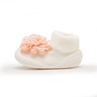 White baby shoe with pink flower.
