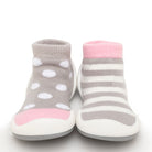 Pair of baby sock shoes, gray with polka dots, and gray and white stripes.