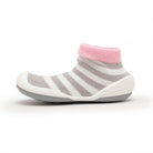 A gray and white striped baby shoe with pink trim.