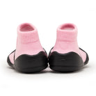 Rear view of pink sock shoes with black soles.