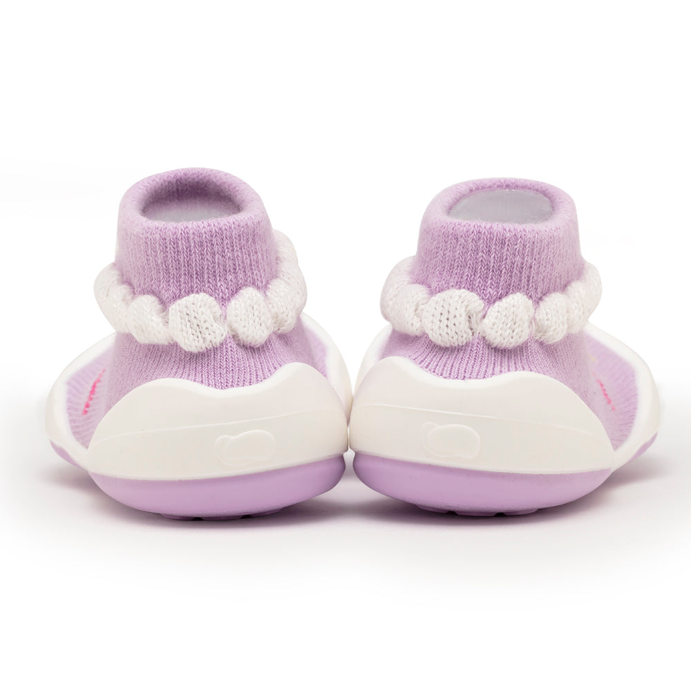 A pair of lilac-purple baby slipper-socks with white accents.