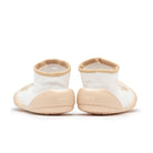 Back view of white sock shoes with beige soles.