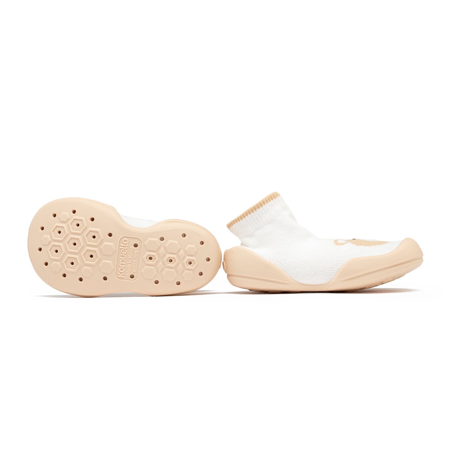 A pair of baby sock shoes with white sock and beige sole.