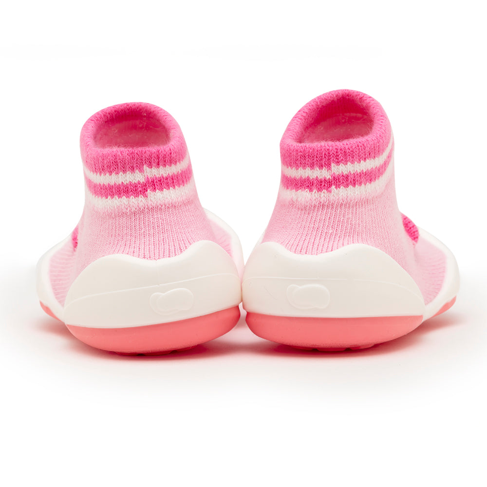 Two pink and white baby shoes.