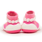Back view of pink and white baby booties.